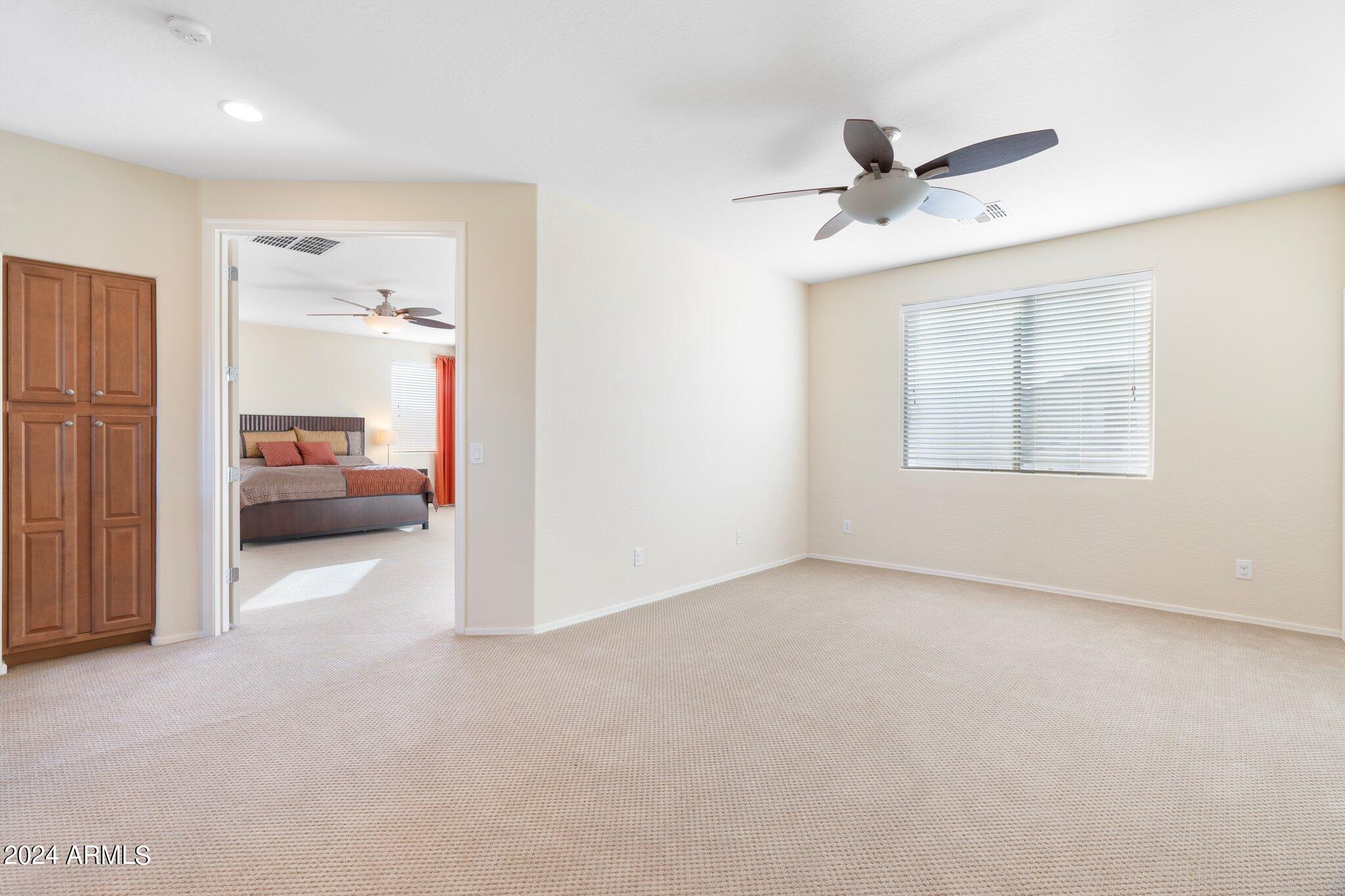 4427 West Summerside Road Laveen, AZ 85339 - Photo 38 of 72 a view of a livingroom with a furniture ceiling fan and window