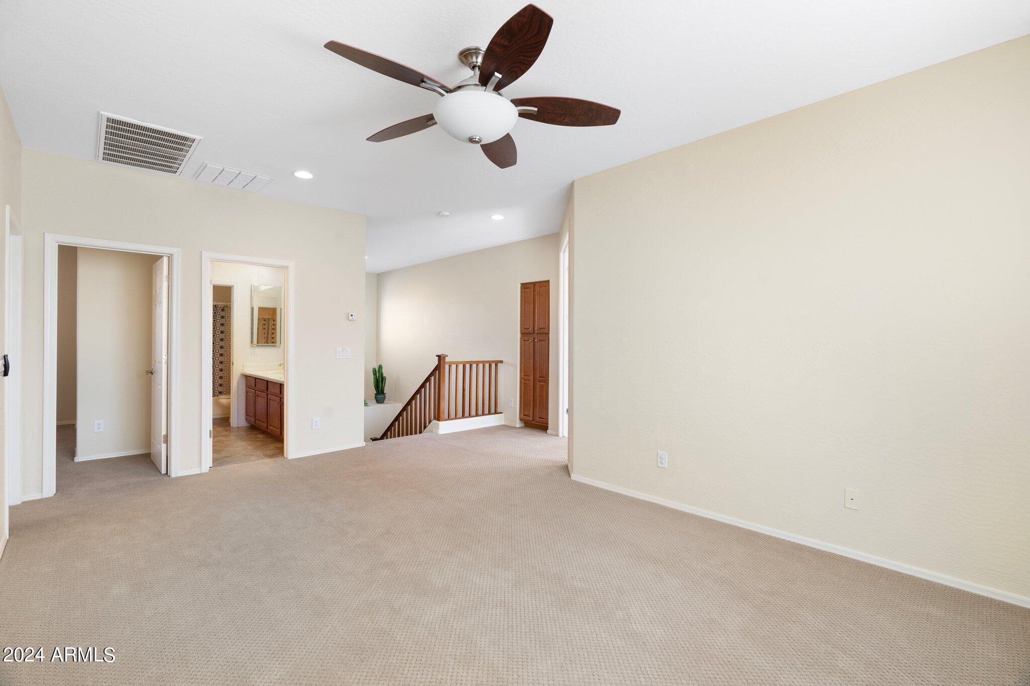 4427 West Summerside Road Laveen, AZ 85339 - Photo 40 of 72 a view of an empty room with a ceiling fan