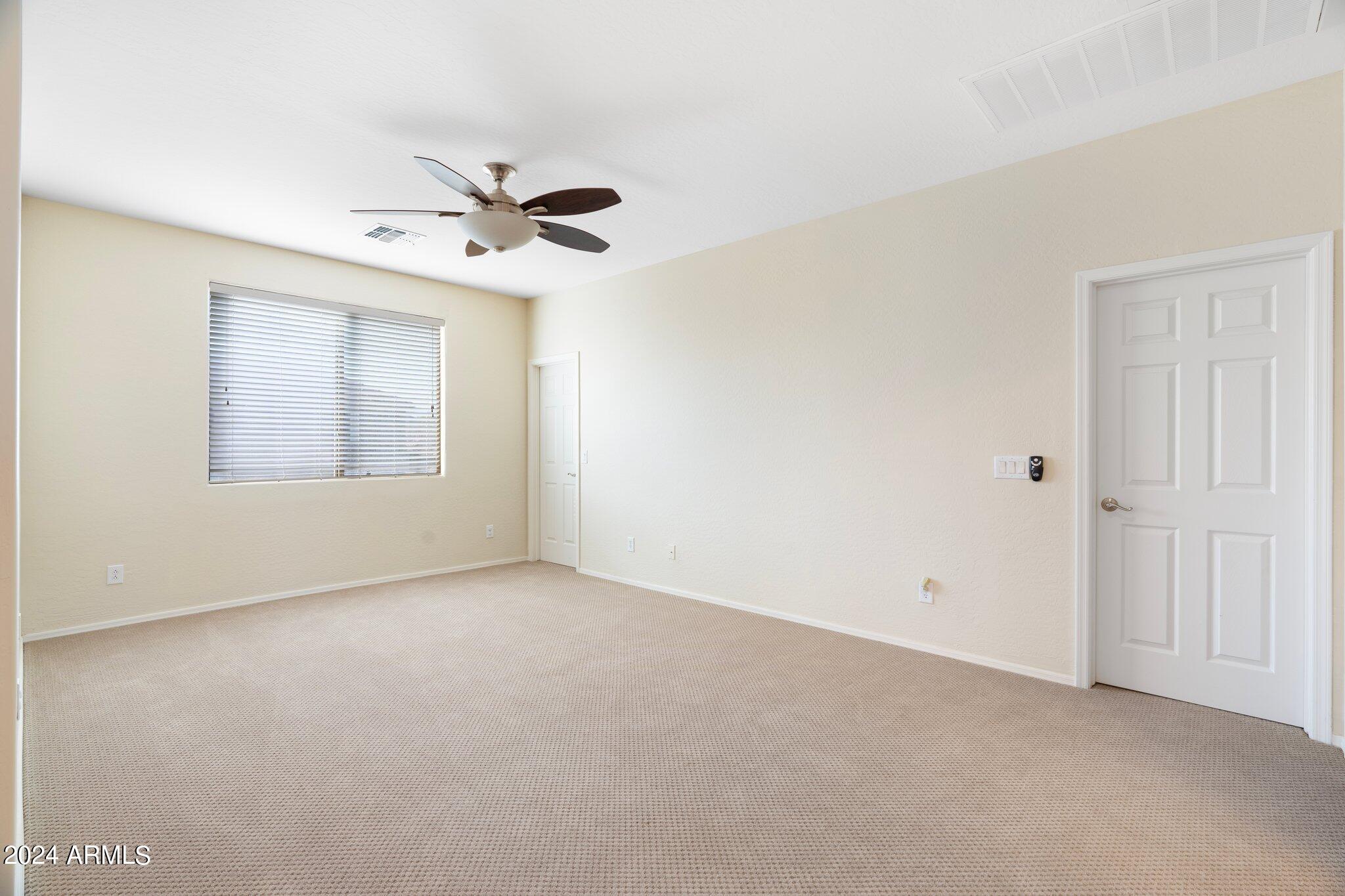 4427 West Summerside Road Laveen, AZ 85339 - Photo 41 of 72 an empty room with windows and fan