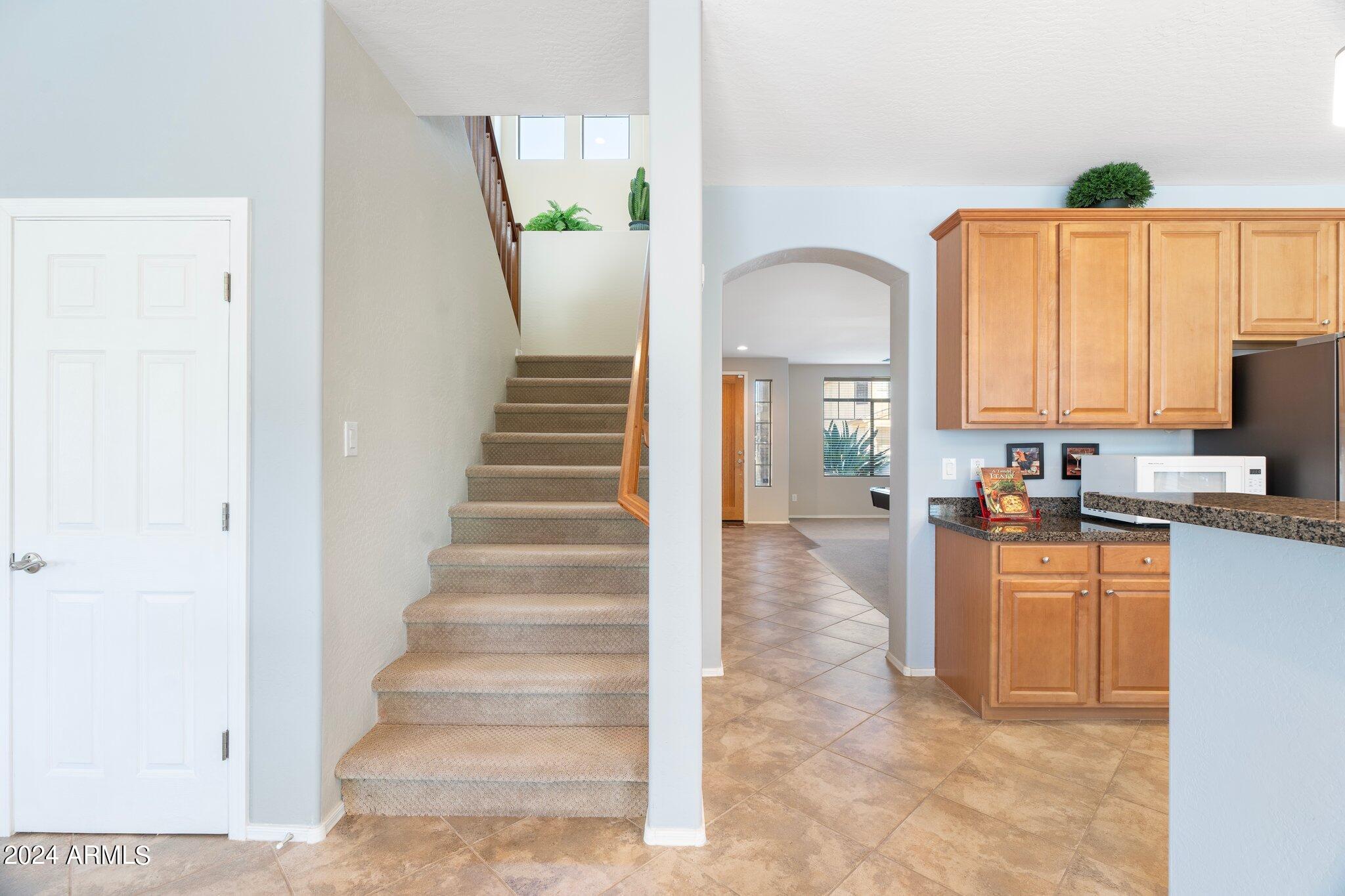 4427 West Summerside Road Laveen, AZ 85339 - Photo 43 of 72 a view of a kitchen with kitchen island wooden floor and living room
