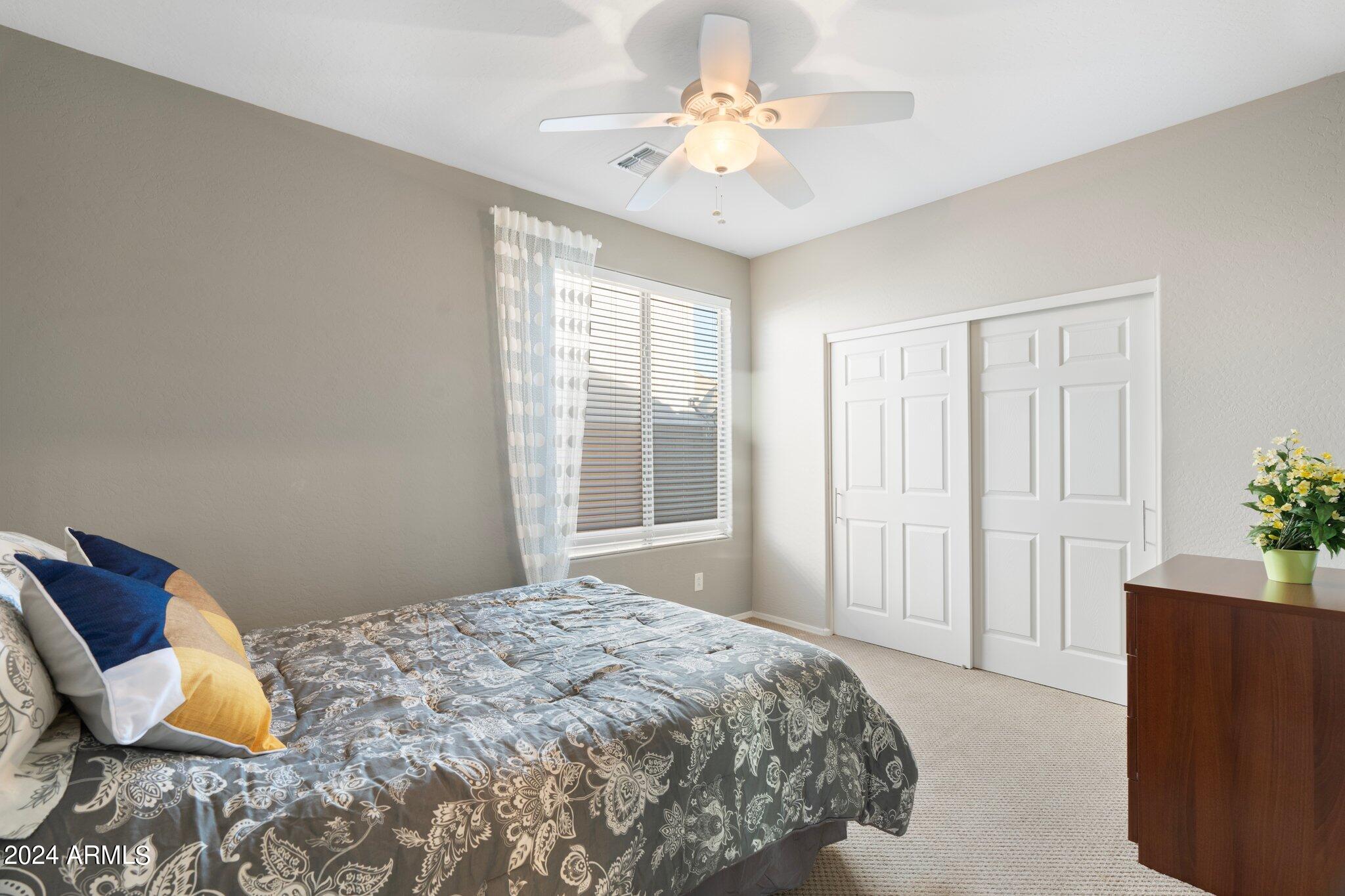 4427 West Summerside Road Laveen, AZ 85339 - Photo 46 of 72 a bedroom with a bed and a chandelier