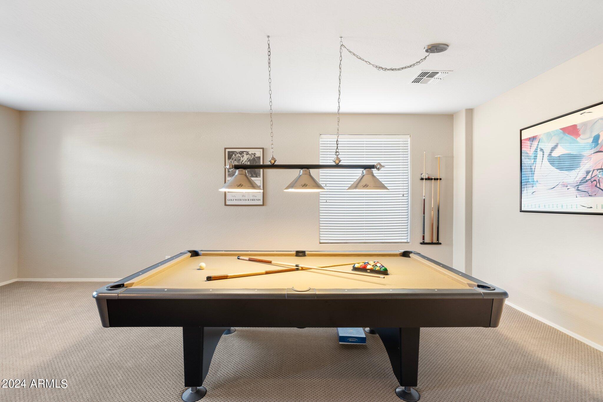 4427 West Summerside Road Laveen, AZ 85339 - Photo 47 of 72 a room with a table chairs and wooden floor