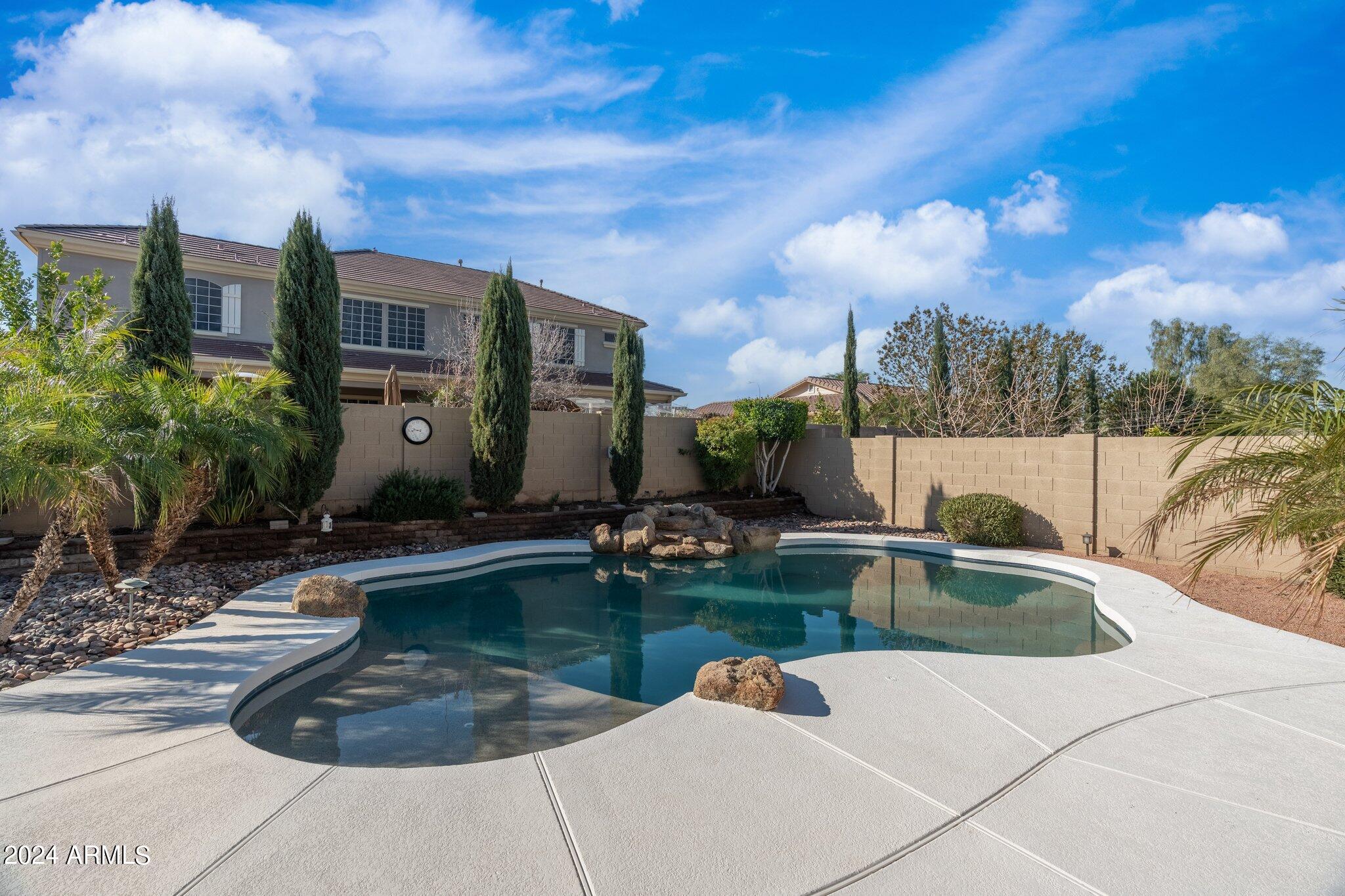 4427 West Summerside Road Laveen, AZ 85339 - Photo 64 of 72 a view of pool with lawn chairs and iron fence