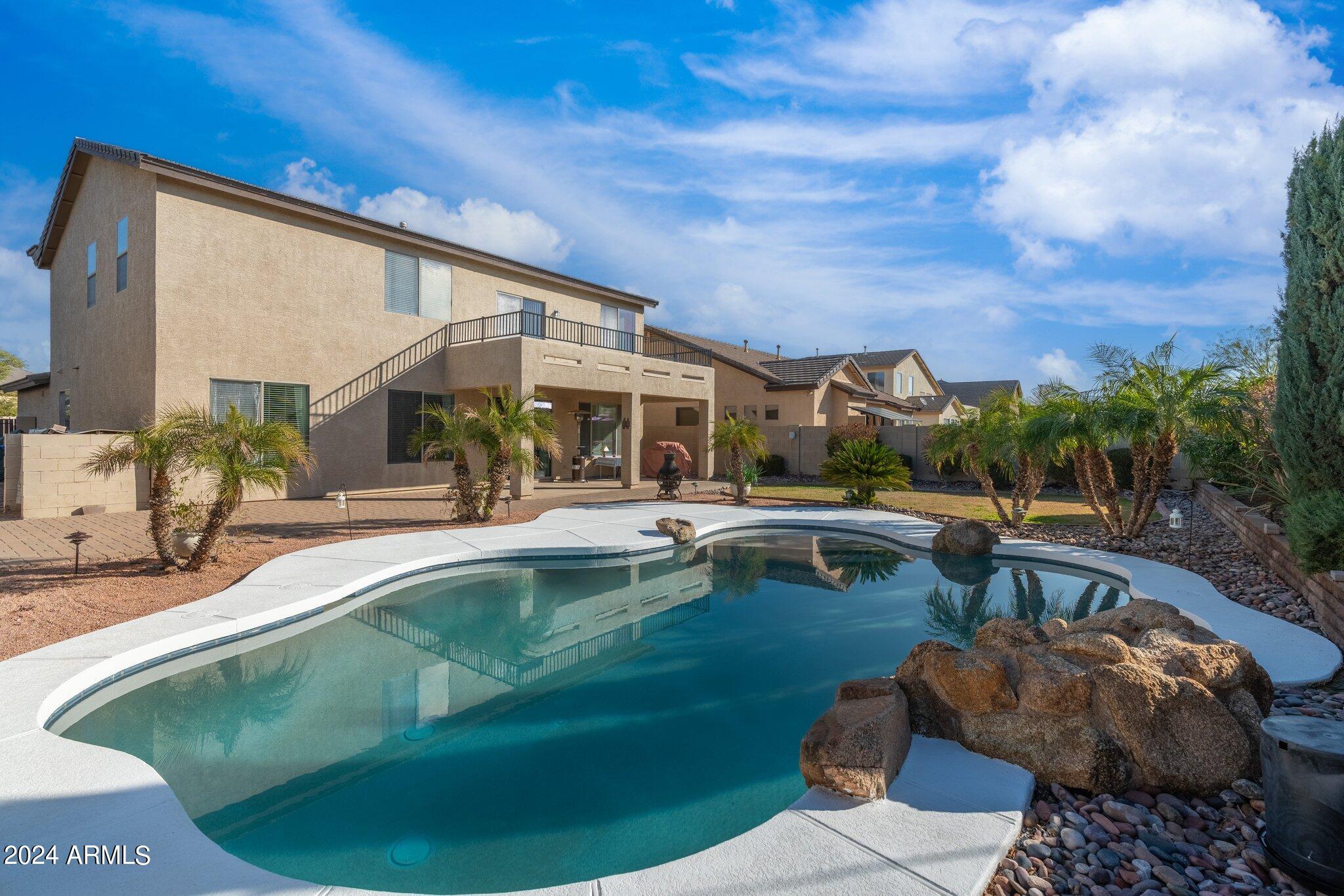 4427 West Summerside Road Laveen, AZ 85339 - Photo 67 of 72 a view of a swimming pool with a patio and a yard