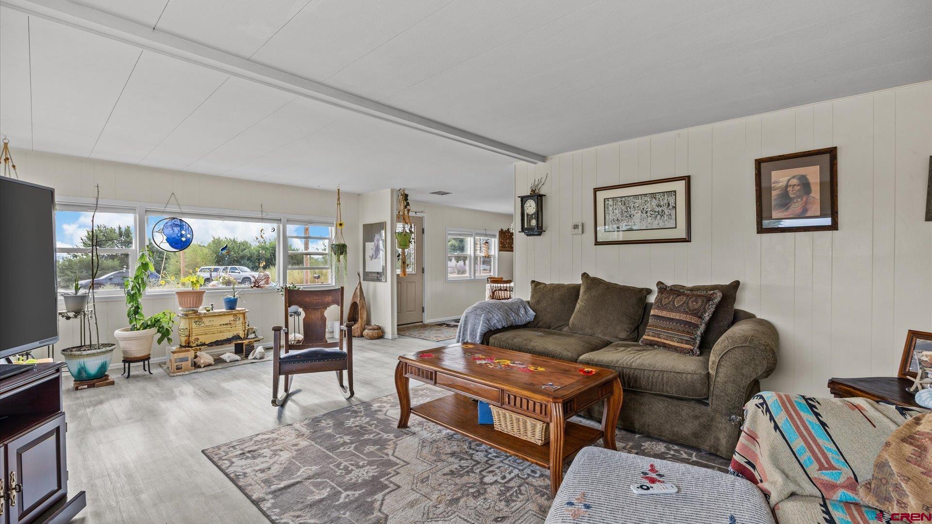 14860 Deer Run Road Delta, CO 81416 - Photo 11 of 33 a living room with furniture a rug and a flat screen tv