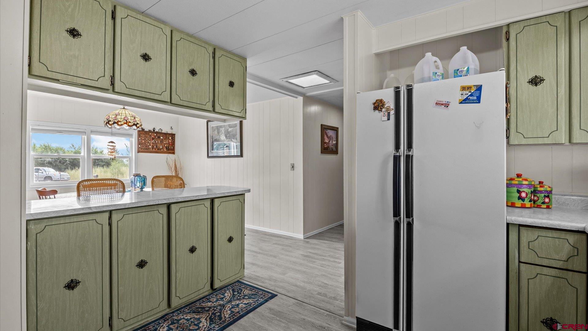 14860 Deer Run Road Delta, CO 81416 - Photo 15 of 33 a white refrigerator freezer sitting inside of a kitchen