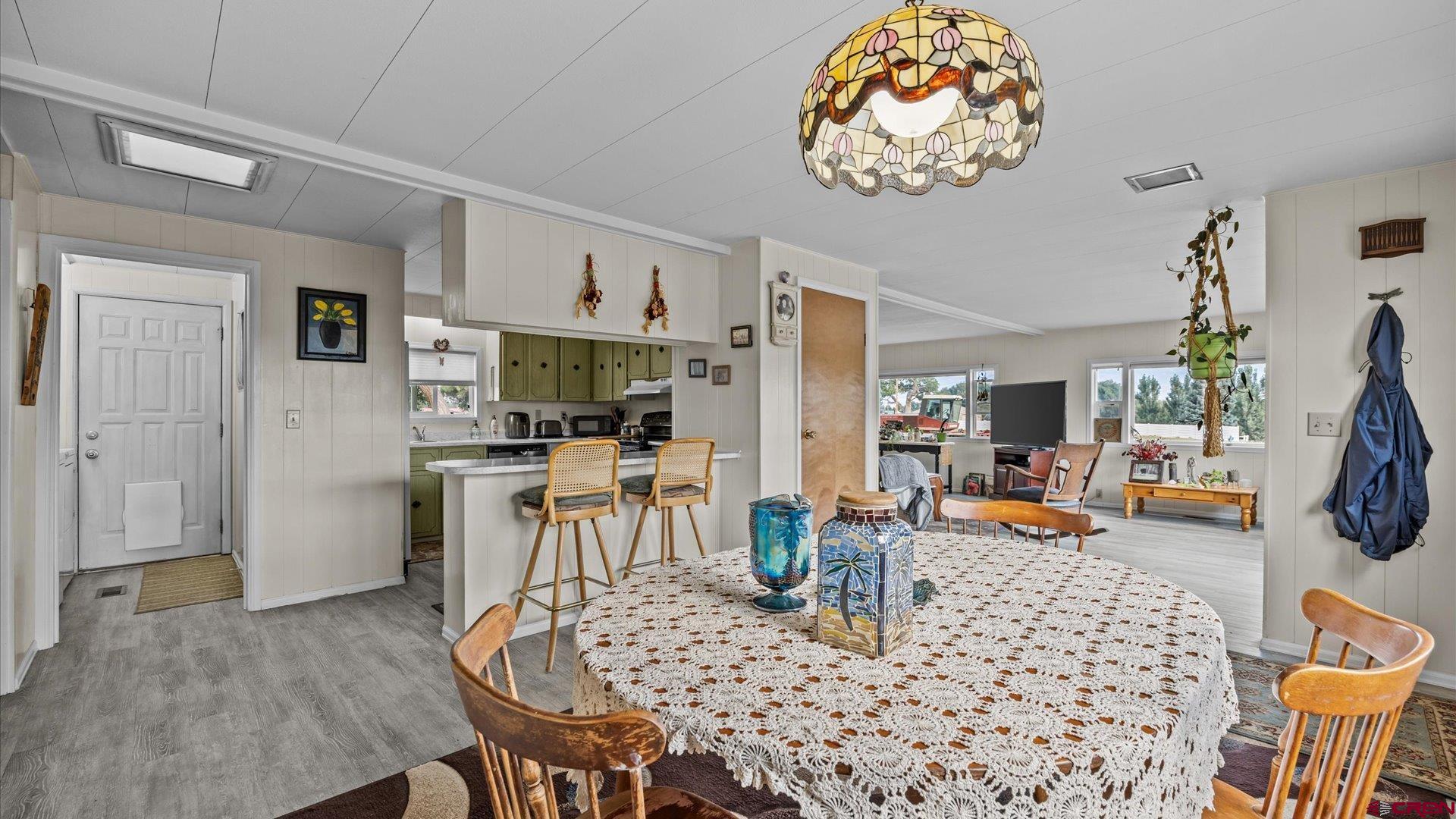 14860 Deer Run Road Delta, CO 81416 - Photo 18 of 33 a dining room with furniture and a dining table with wooden floor