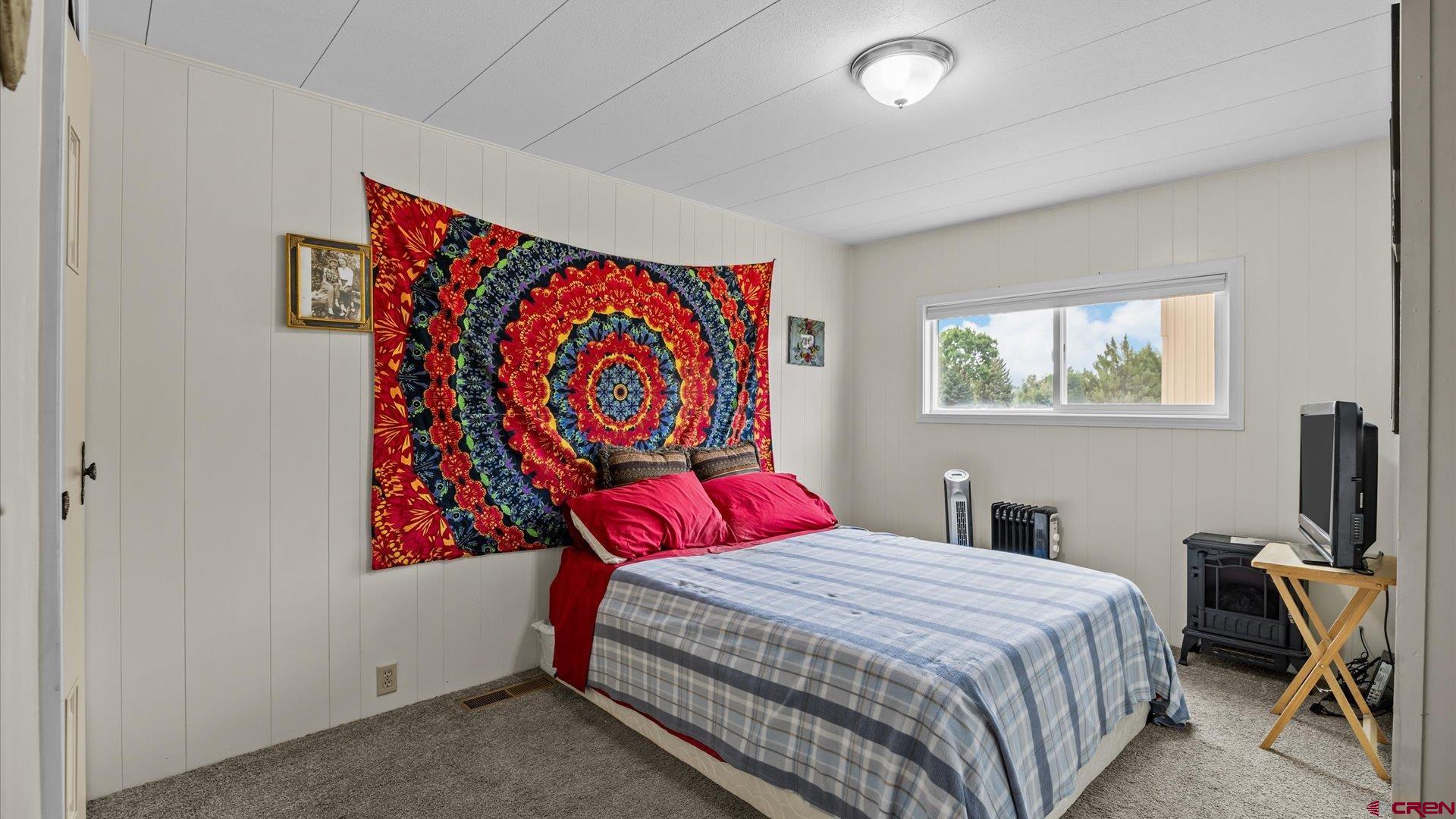 14860 Deer Run Road Delta, CO 81416 - Photo 22 of 33 a bedroom with a bed and a dresser