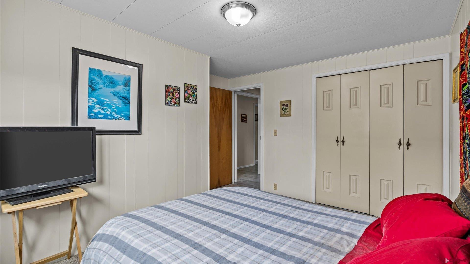14860 Deer Run Road Delta, CO 81416 - Photo 23 of 33 a bedroom with a bed and a flat screen tv