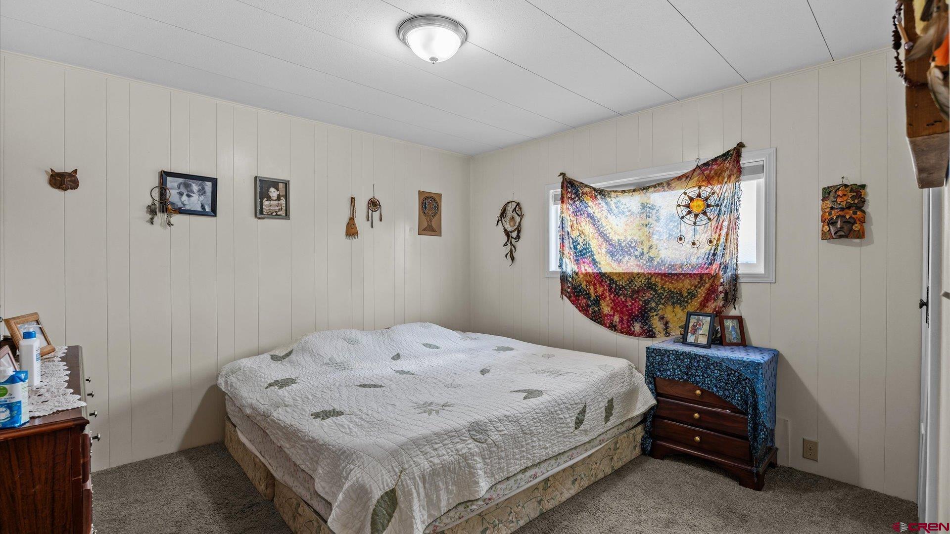14860 Deer Run Road Delta, CO 81416 - Photo 24 of 33 a bedroom with a bed and a wall painting
