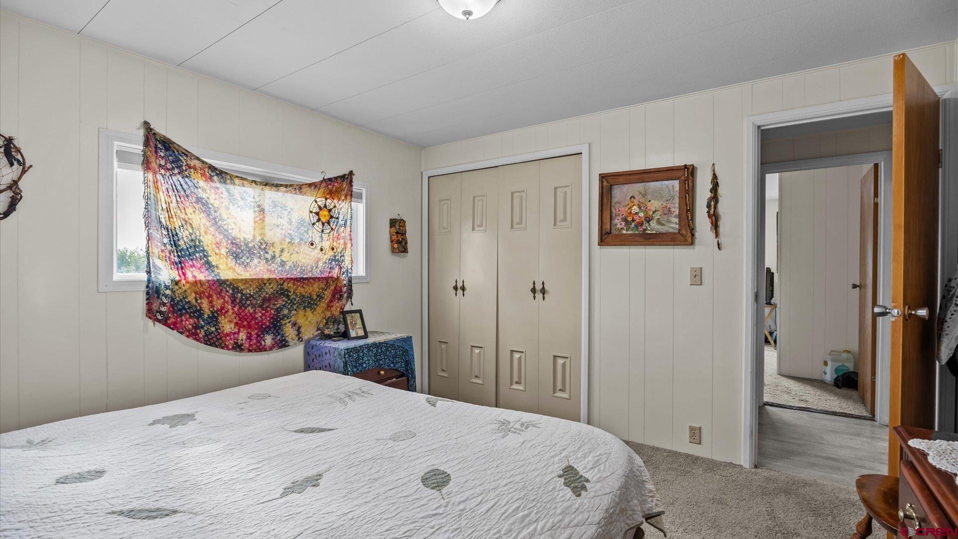 14860 Deer Run Road Delta, CO 81416 - Photo 25 of 33 a bedroom with a bed and painting on the wall