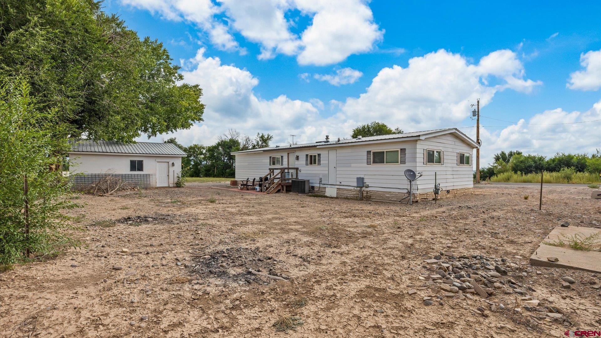 14860 Deer Run Road Delta, CO 81416 - Photo 29 of 33 a view of a house with a backyard