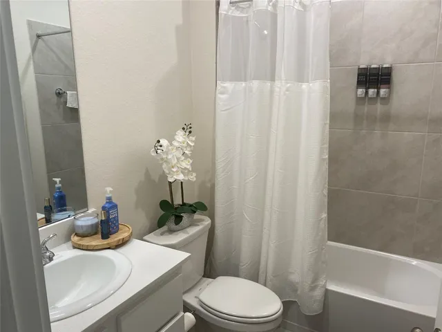 a white toilet sitting next to a bathroom sink