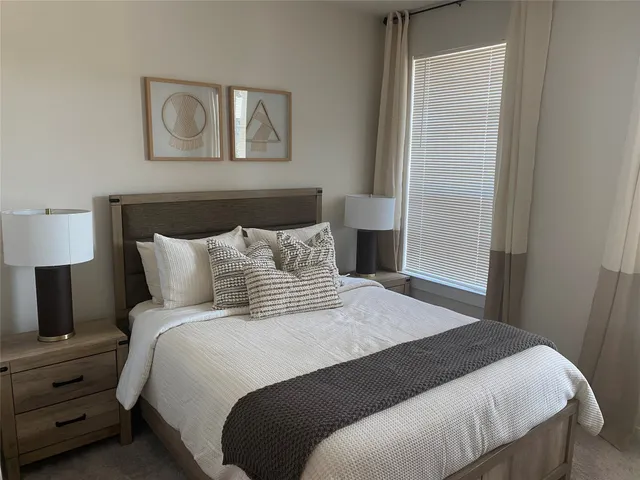 a bedroom with a bed and a lamp