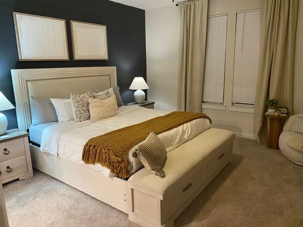 a bedroom with a bed and a night stand