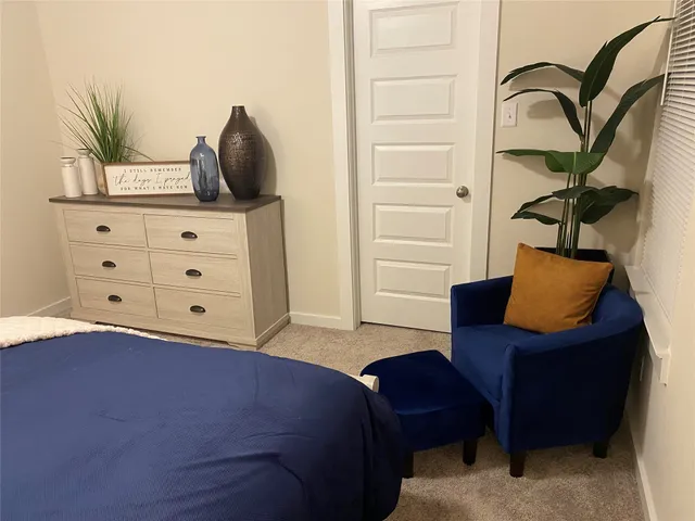 a bedroom with a bed and with furniture