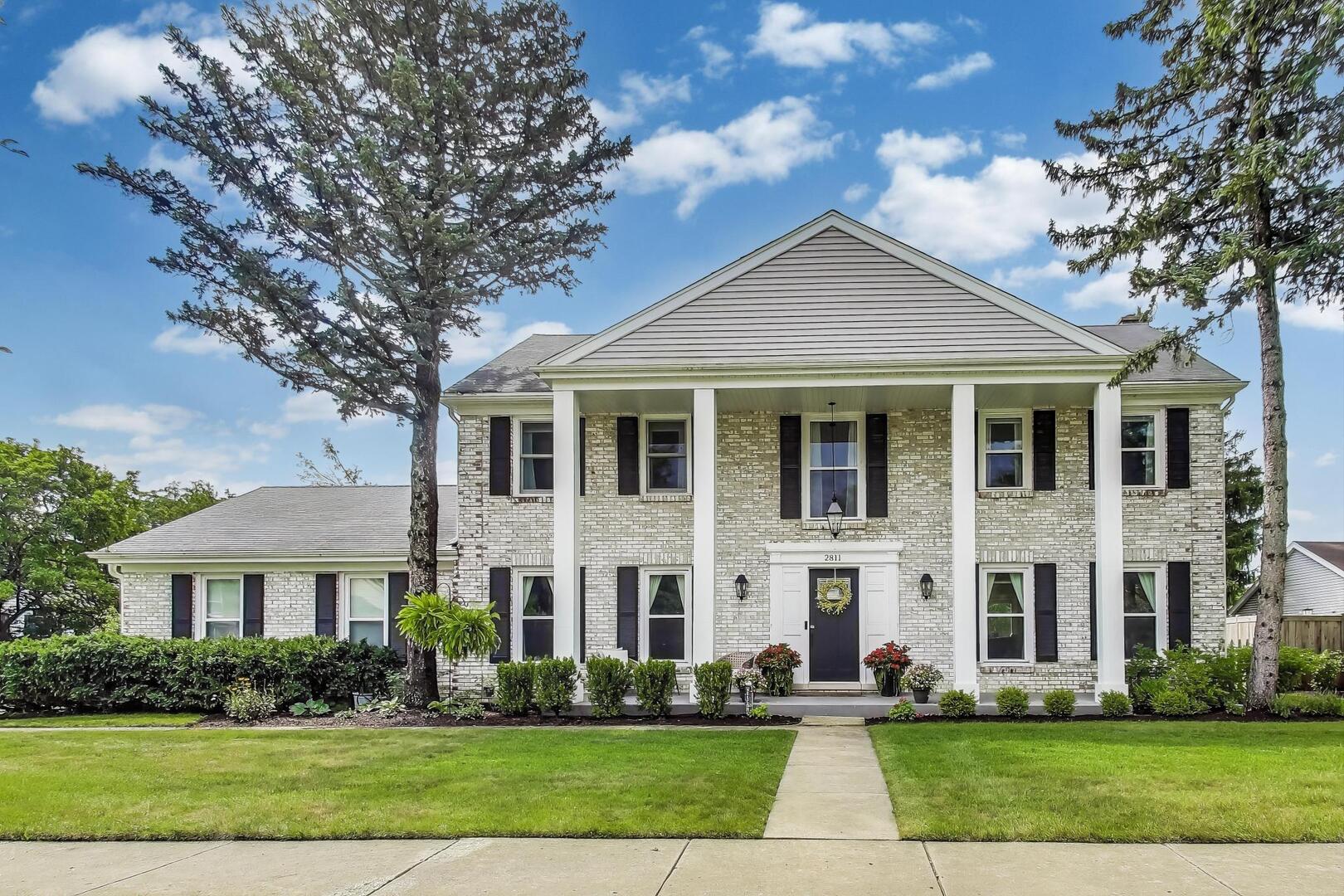 2811 Farmington Road Northbrook, IL 60062 - Photo 1 of 45 a front view of a house with a yard and trees