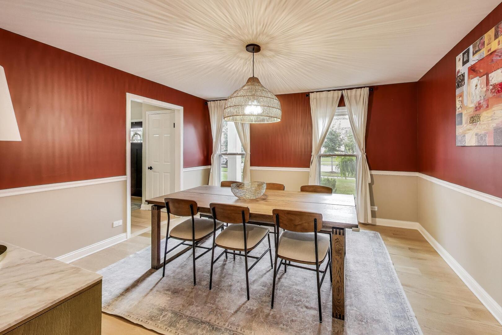 2811 Farmington Road Northbrook, IL 60062 - Photo 11 of 45 a dining room with wooden floor a chandelier a wooden table and chairs