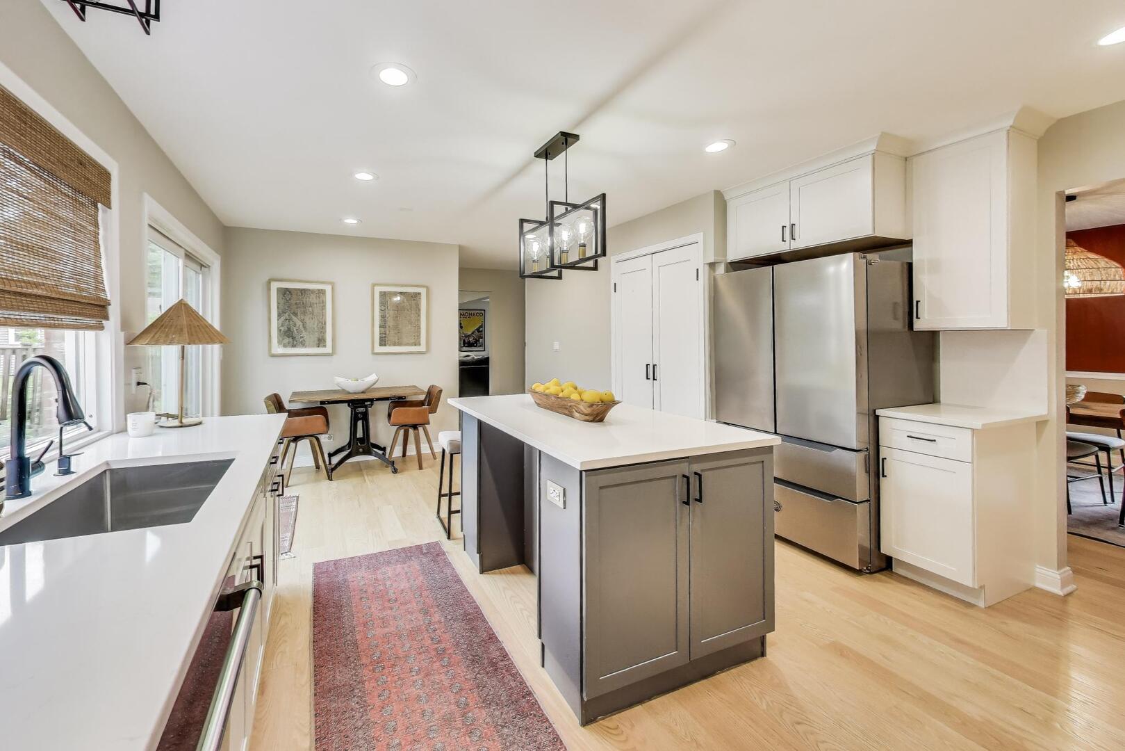 2811 Farmington Road Northbrook, IL 60062 - Photo 14 of 45 a kitchen with a refrigerator a sink dishwasher a oven and a dining table with wooden floor