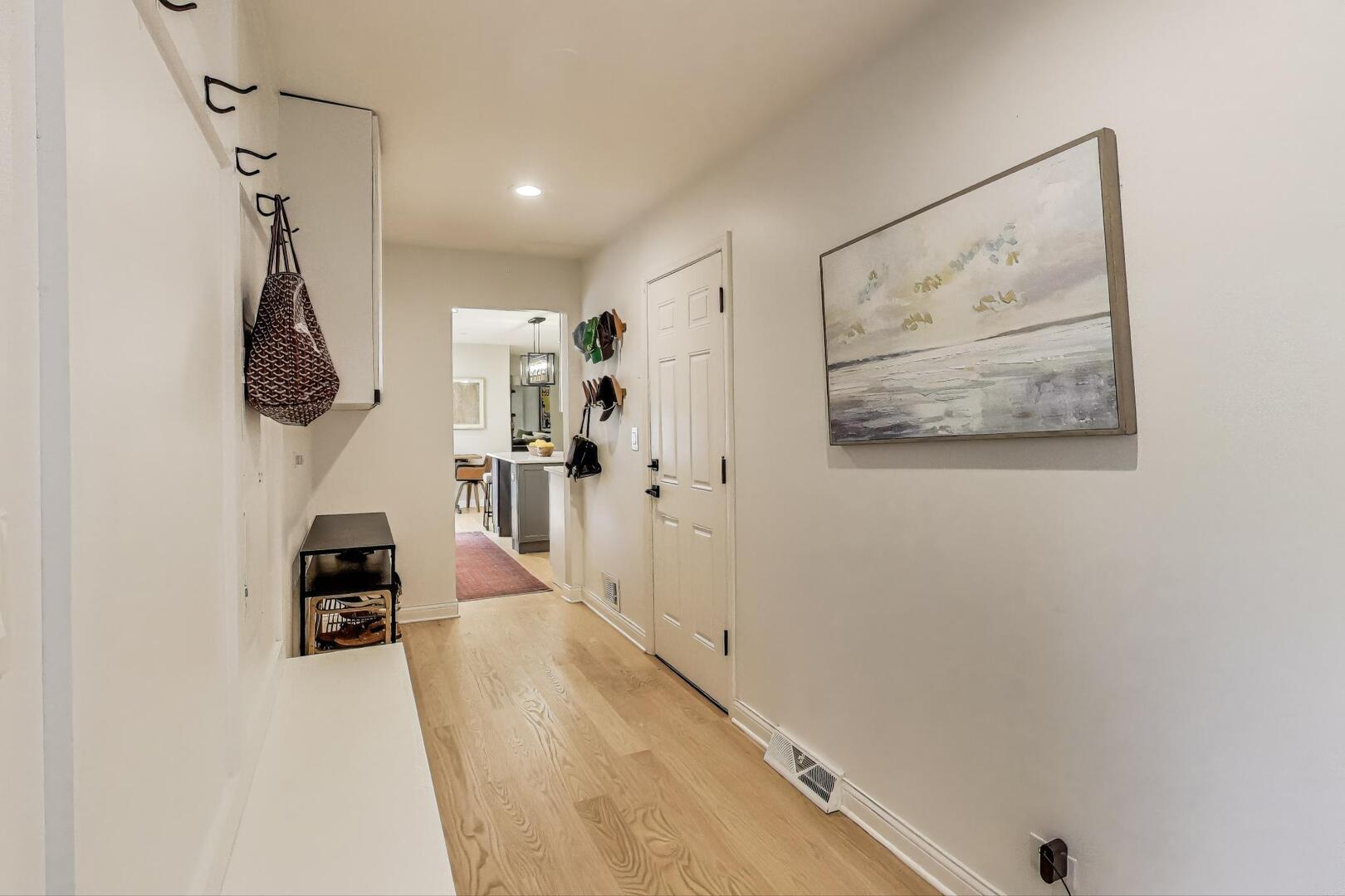 2811 Farmington Road Northbrook, IL 60062 - Photo 19 of 45 a hallway with a white cabinets and wooden floor