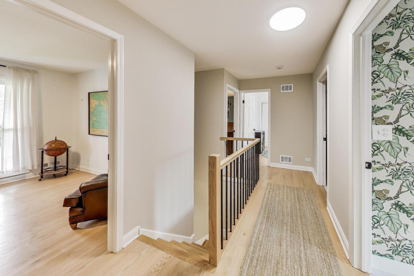2811 Farmington Road Northbrook, IL 60062 - Photo 20 of 45 a view of a hallway to a livingroom with wooden floor and furniture