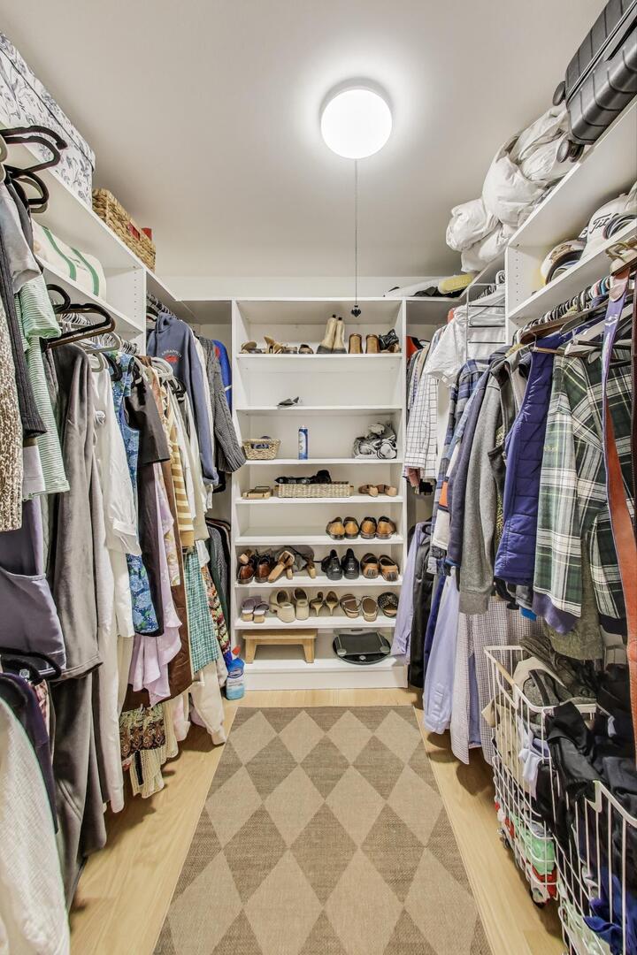 2811 Farmington Road Northbrook, IL 60062 - Photo 26 of 45 a view of walk in closet with clothes and shoes