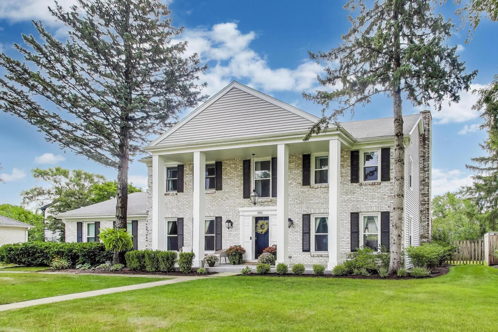 2811 Farmington Road Northbrook, IL 60062 - Photo 3 of 45 a front view of a house with a garden and plants