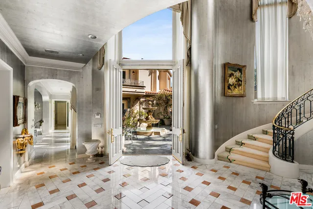 a bedroom with a bed and glass door