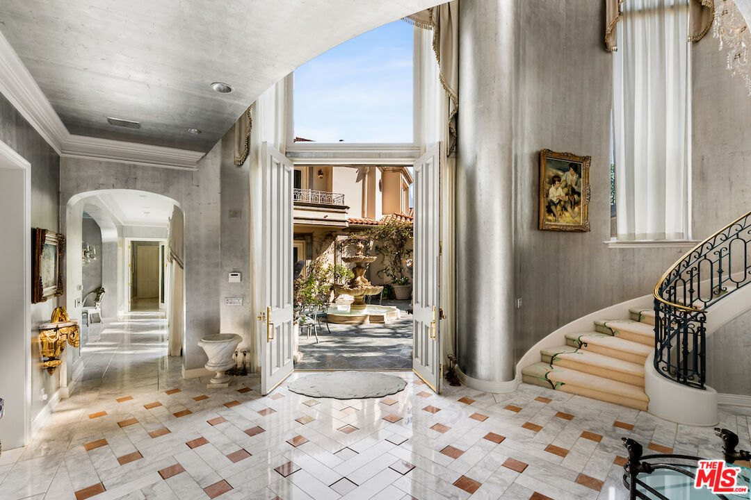 a bedroom with a bed and glass door