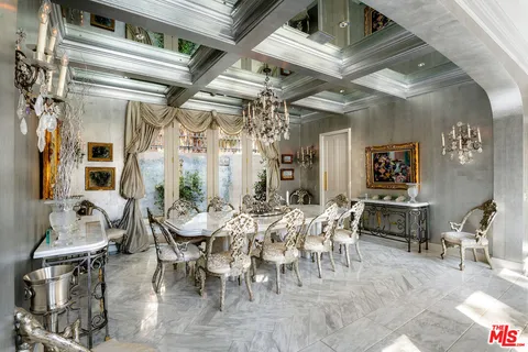 a view of a dining room with furniture and chandelier