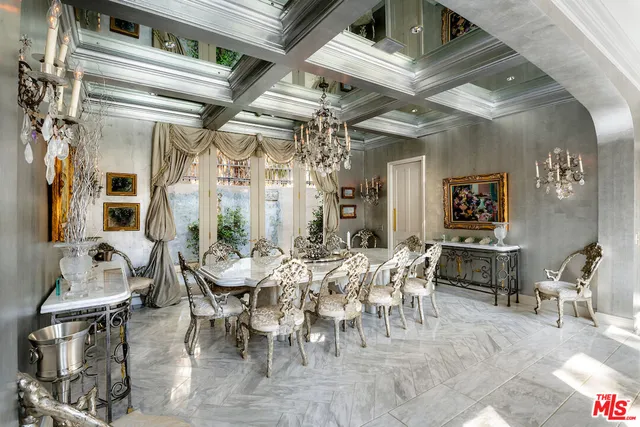 a view of a dining room with furniture and chandelier