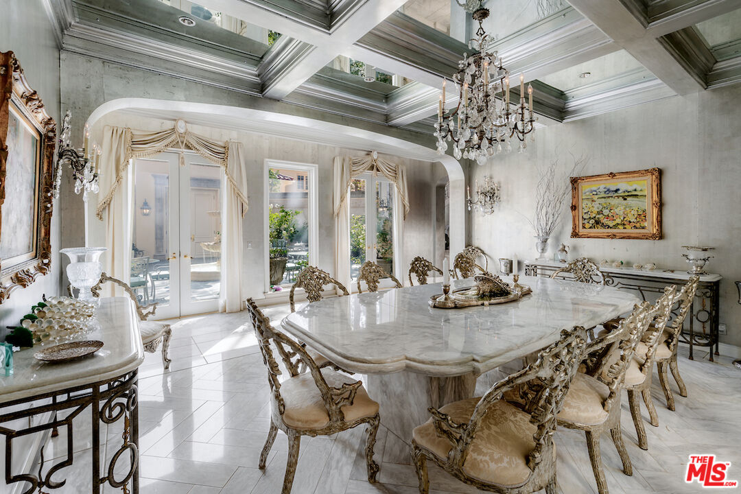 10275 Century Woods Drive Los Angeles, CA 90067 - Photo 13 of 42 a view of a dining room with furniture and chandelier