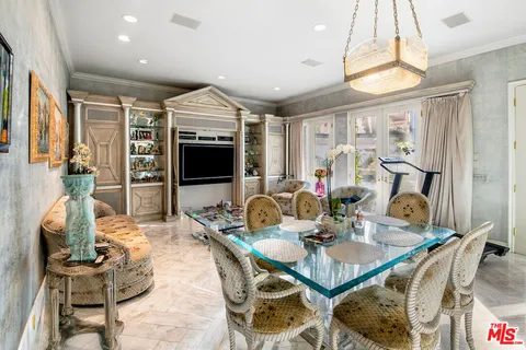 a dining room with furniture a chandelier and window
