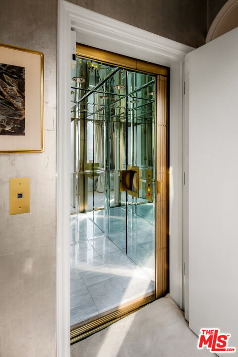 10275 Century Woods Drive Los Angeles, CA 90067 - Photo 17 of 42 a view of a hallway with a glass door