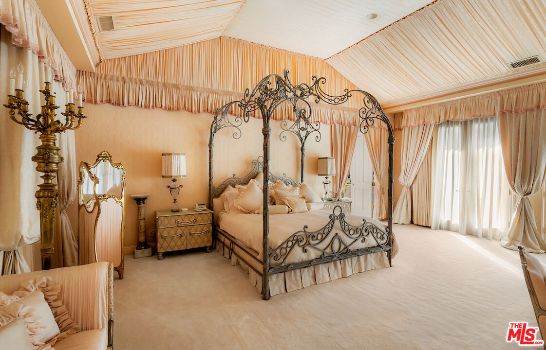 10275 Century Woods Drive Los Angeles, CA 90067 - Photo 22 of 42 a spacious bedroom with a bed and a chandelier
