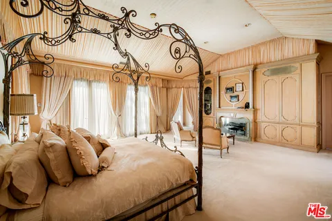 a bedroom with furniture and a window