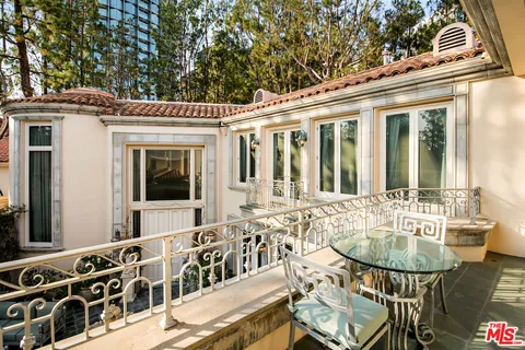 a view of a patio with table and chairs with wooden floor and fence