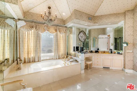 a large white kitchen with a large window