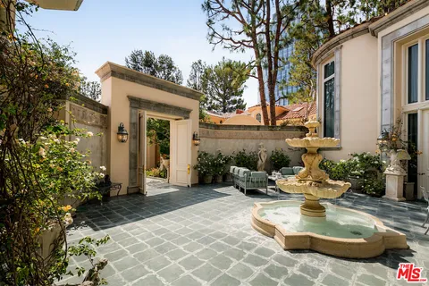 a view of a patio with chair and tables back yard of the house