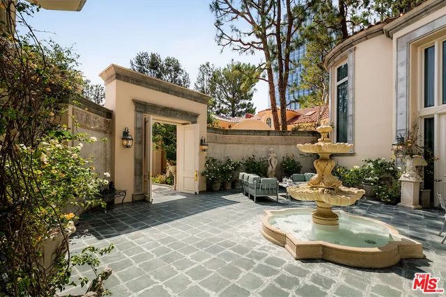 a view of a patio with chair and tables back yard of the house