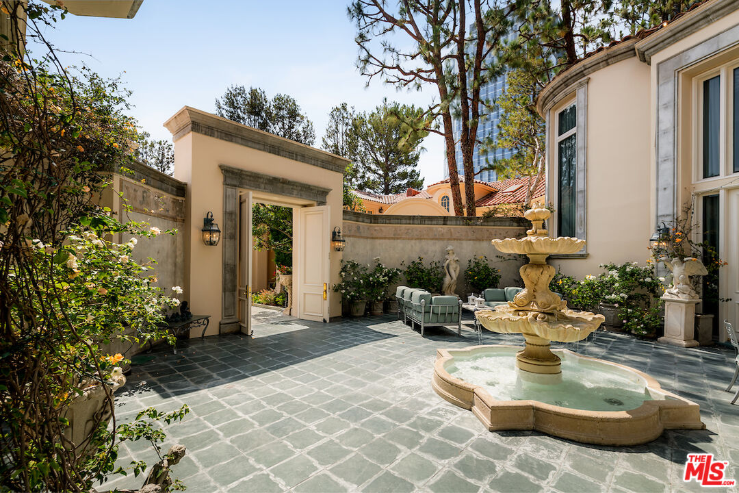 10275 Century Woods Drive Los Angeles, CA 90067 - Photo 4 of 42 a view of a patio with chair and tables back yard of the house