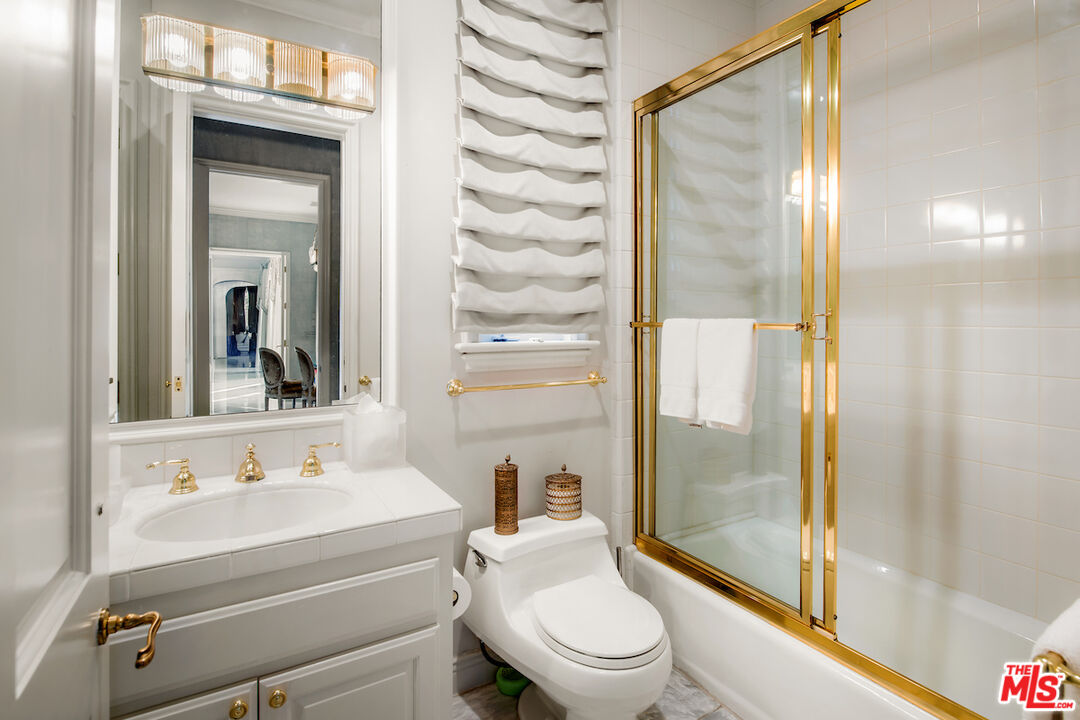 10275 Century Woods Drive Los Angeles, CA 90067 - Photo 42 of 42 a bathroom with a sink a mirror and a shower