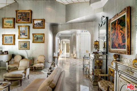 a living room with furniture and painting on the wall