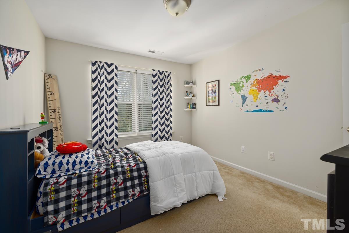 155 Writing Rock Place Apex, NC 27539 - Photo 27 of 33 a bedroom with a bed and a window