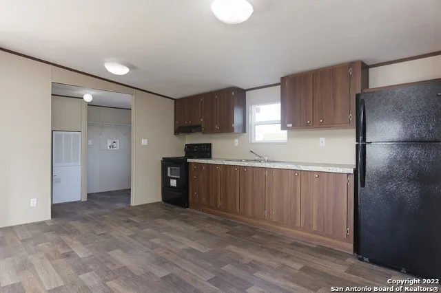 a kitchen with a refrigerator and a sink