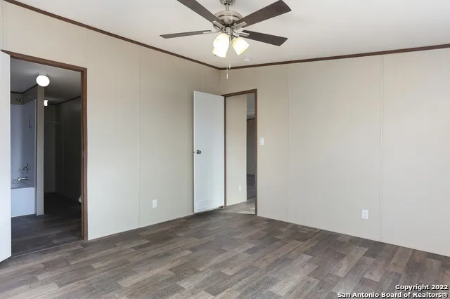 a view of a livingroom with a ceiling fan and wooden floor