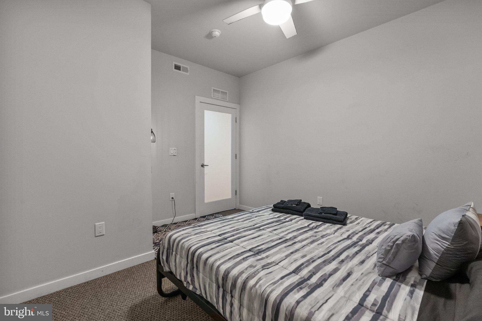 1608 Ridge Avenue, Unit 302 Philadelphia, PA 19130 - Photo 19 of 24 a bedroom with a bed and a chandelier