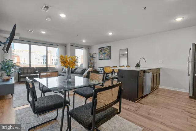 a kitchen with stainless steel appliances granite countertop a refrigerator a sink a stove and wooden cabinets