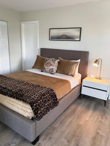 a bed sitting in a bedroom next to a window