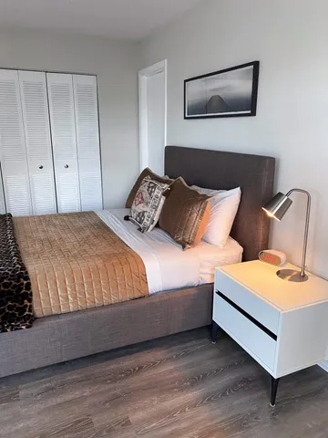 a bedroom with a bed and lamp